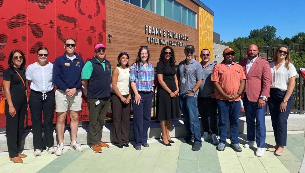 Group of zoo and utility company officials pose for photo.