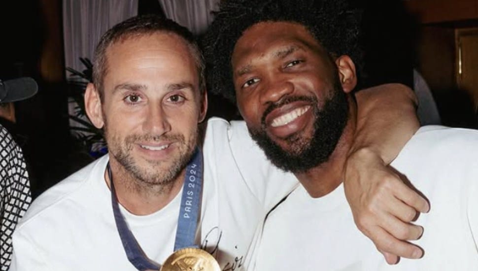 Michael Rubin smiles with Joel Embiid at the Paris Olympics.