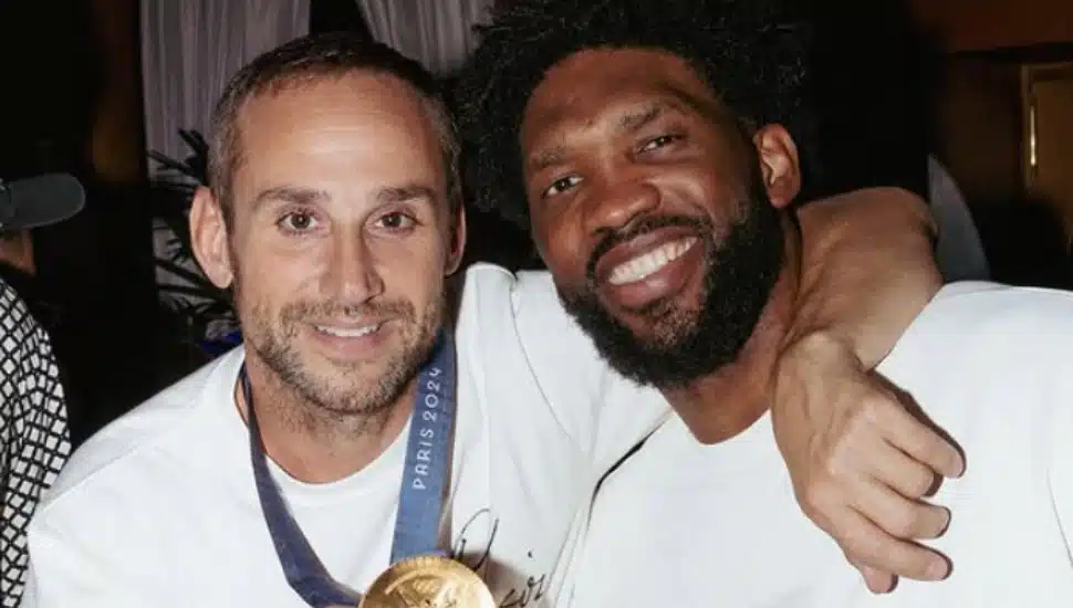 Michael Rubin smiles with Joel Embiid at the Paris Olympics.
