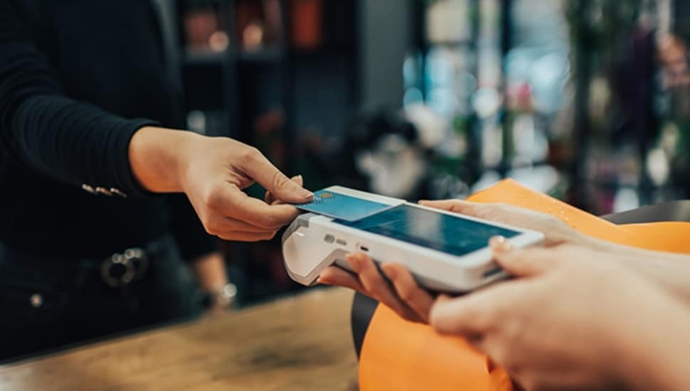 Customer uses credit card to pay bill at retail store.