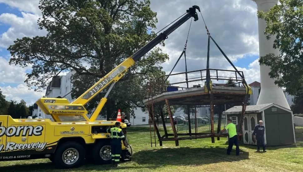 Top of Willow Grove air traffic control tower lifted by crane.