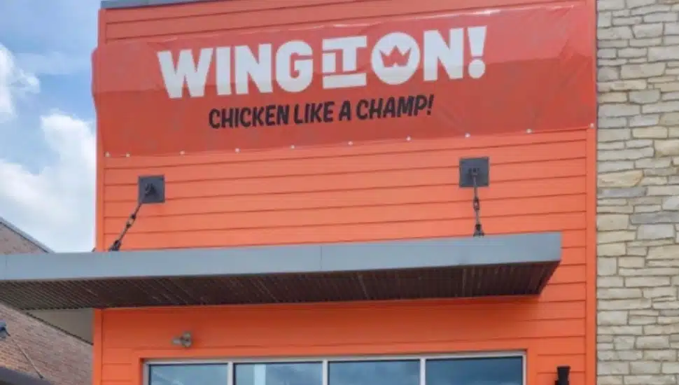 The Wing It On sign hangs above the restaurant.