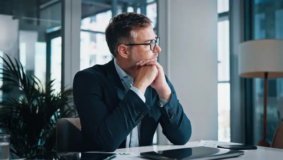 Businessman thinking in office.