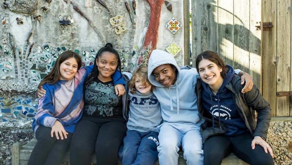 Middle school students pose for a group photo.
