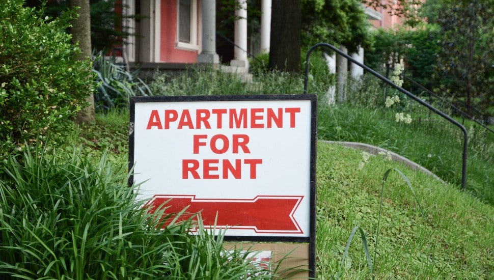 Apartment for Rent sign in a front yard