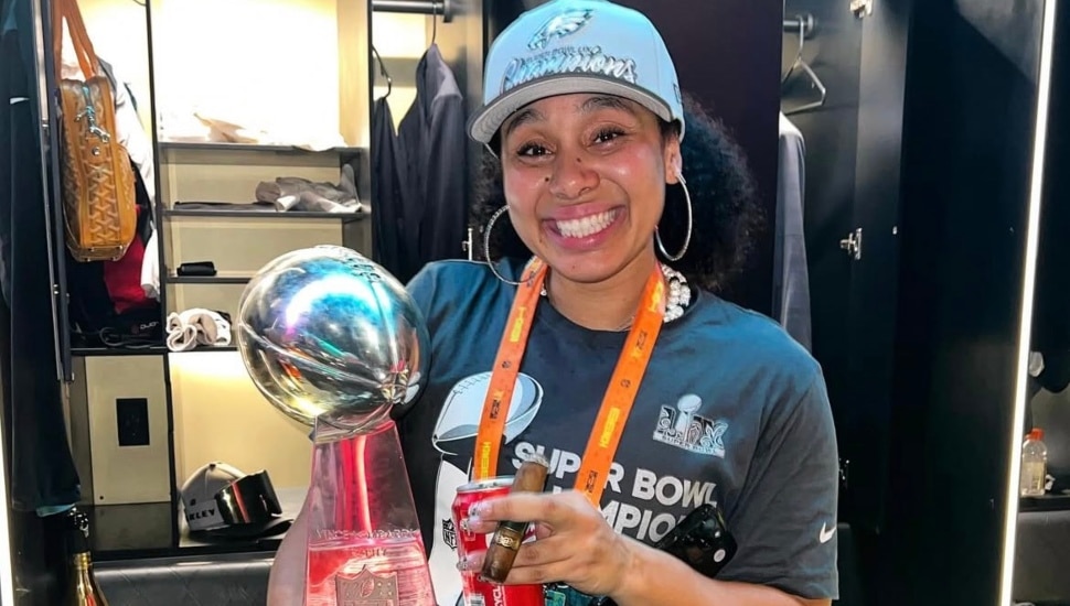 Autumn Lockwood celebrating with an Eagles hat and Lombardi trophy.