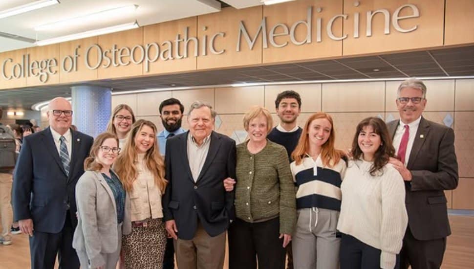 Jim and Celeste Nasuti standing with family in Duquesne University's College of Osteopathic Medicine.