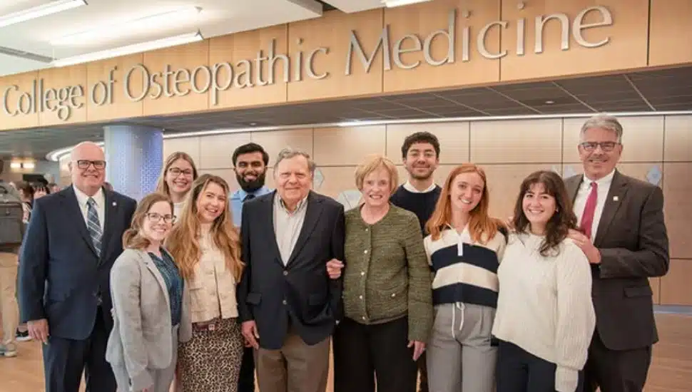 Jim and Celeste Nasuti standing with family in Duquesne University's College of Osteopathic Medicine.