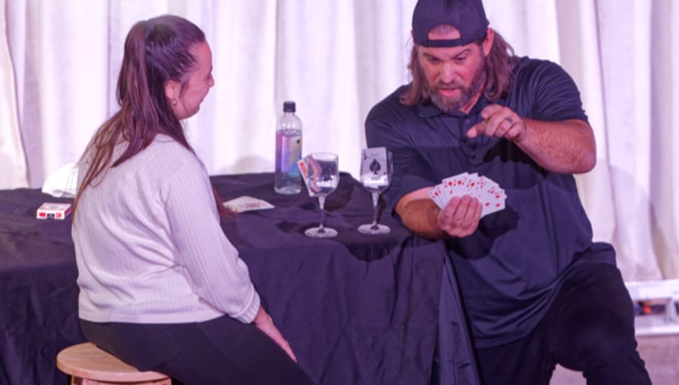 Magician performs for corporate audience.