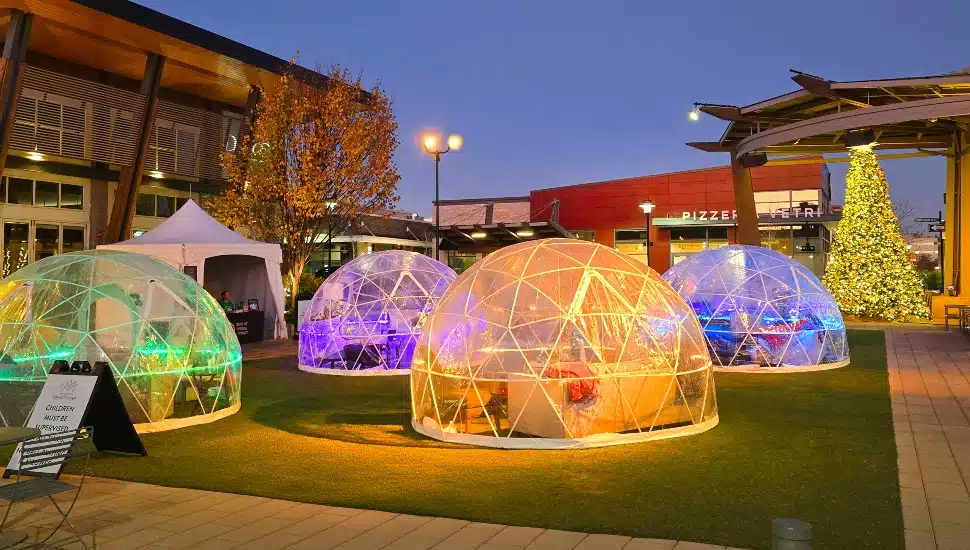 Plastic igloos for dining on green space in town center.