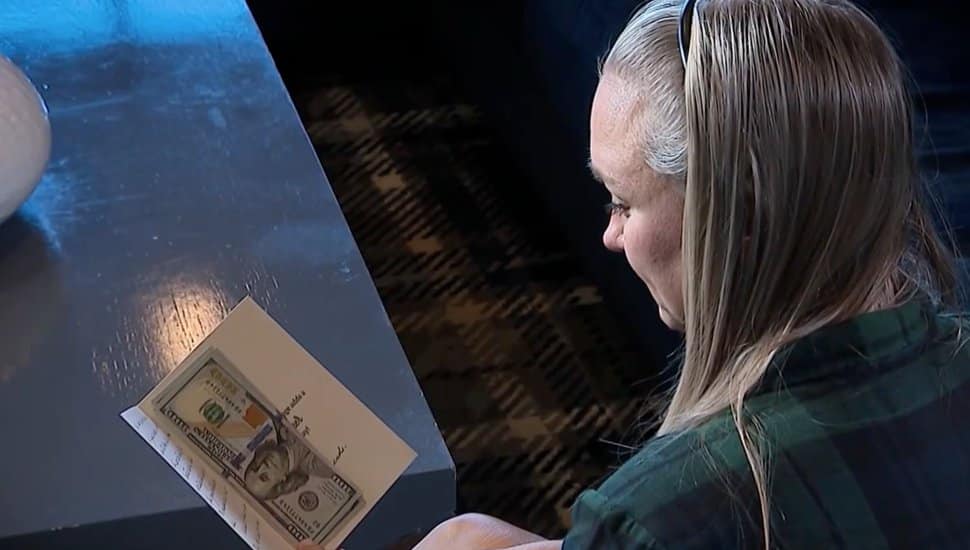 Aaron WIlliams-Higgins reads a charitable card she received anonymously.