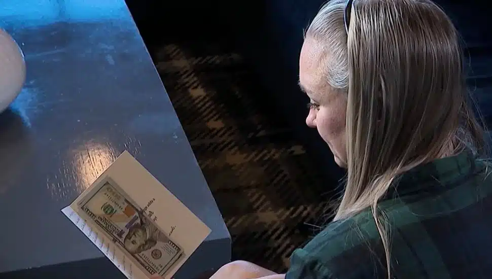 Aaron WIlliams-Higgins reads a charitable card she received anonymously.