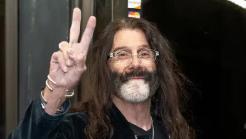 Pierre Robert holds up the peace sign.
