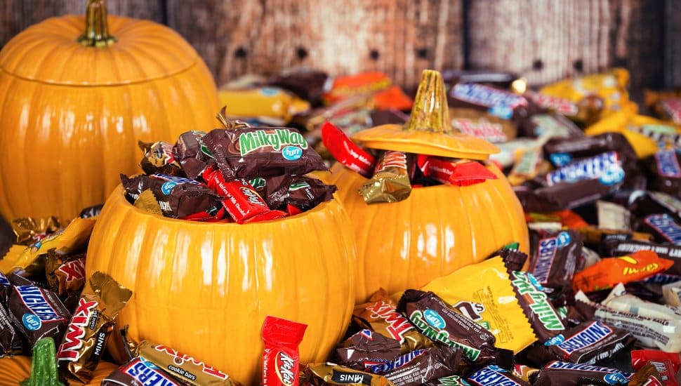 Decorative pumpkins filled with assorted Halloween chocolate candy made by Mars, Incorporated and the Hershey Company.