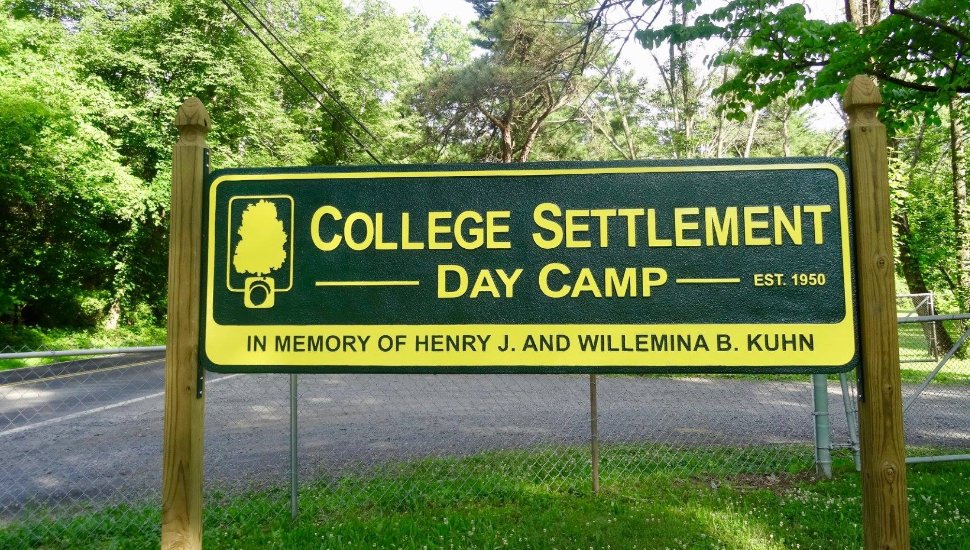 The wooden sign for The College Settlement Day Camp.