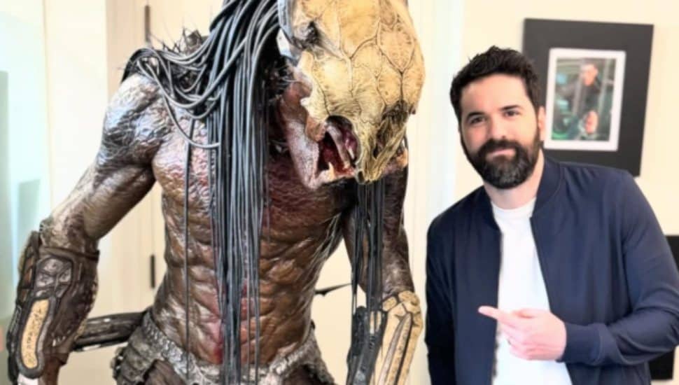 Dan Trachtenberg with a statue of Predator.