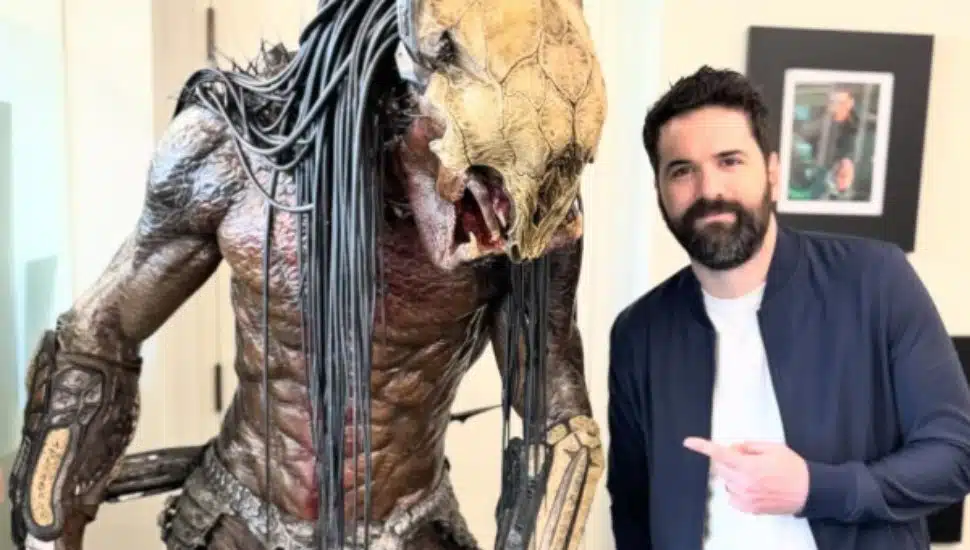 Dan Trachtenberg with a statue of Predator.