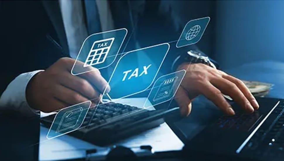 Businessman does taxes on his laptop.