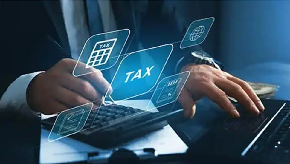 Businessman does taxes on his laptop.