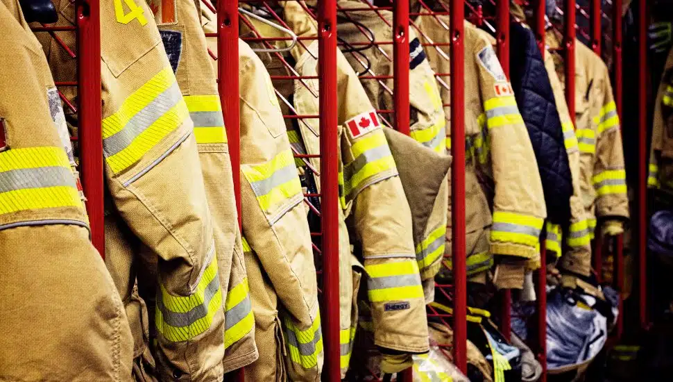 Firefighter uniforms lined up in lockers.