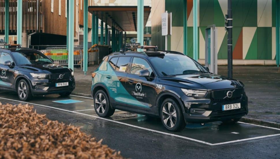 Two cars parked on InductEV charging pads.