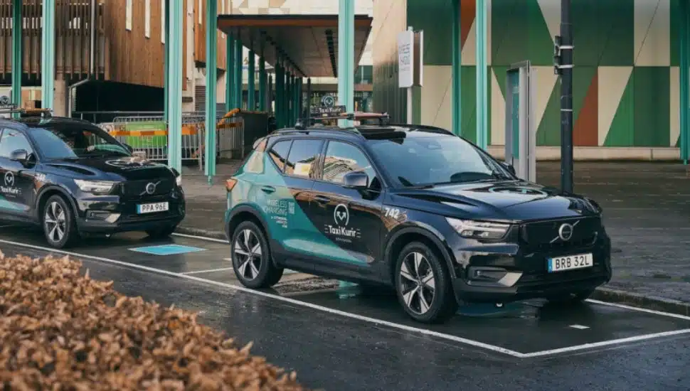 Two cars parked on InductEV charging pads.