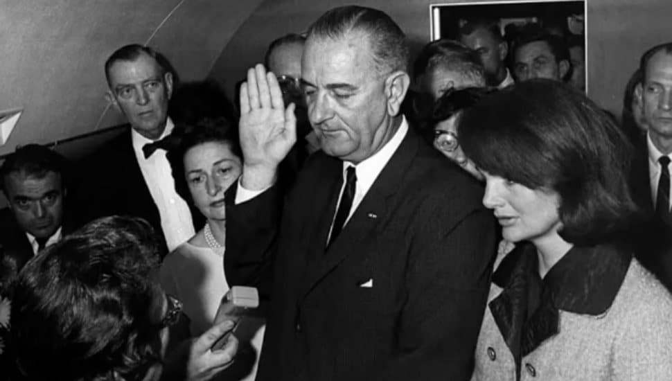 Lyndon B. Johnson swearing into office next to Jackie Kennedy.