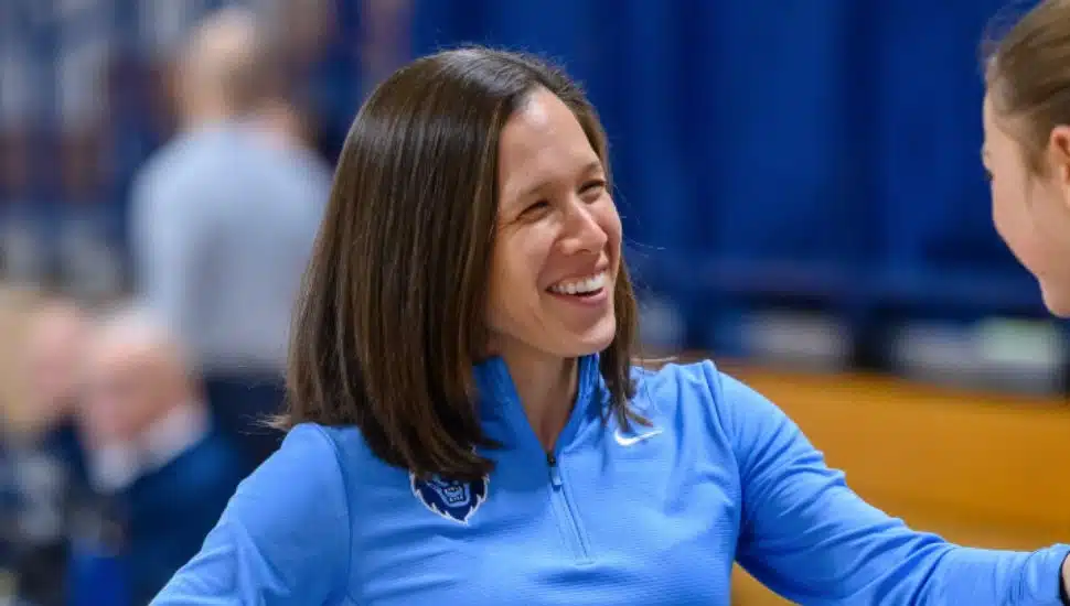 Megan Griffith greets a player on the court.