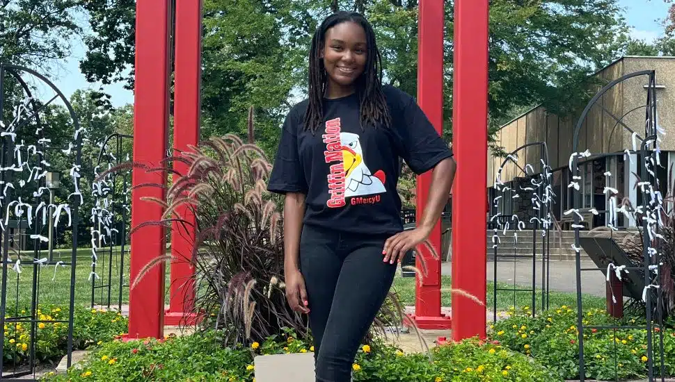 Female college student poses for picture on campus.