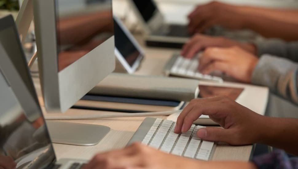 Hands at keyboards.