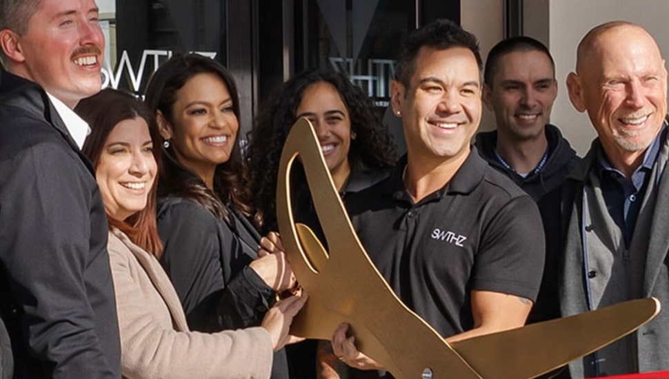 Company's founders cut ribbon at new location.