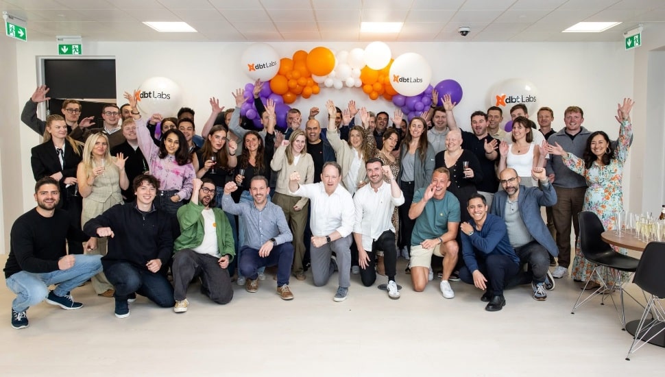 dbt Labs team with balloons in the background.