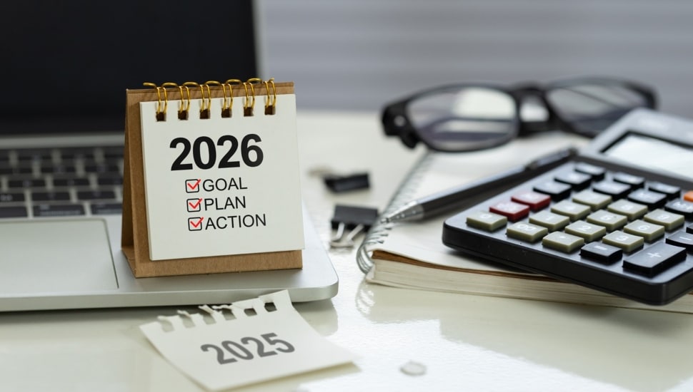 Desk calendar 2026 with checklist Goal, Plan, Action on office workspace.