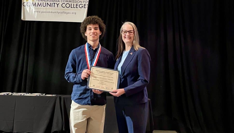 Massimiliano Simon and Dr. Vicki Bastecki-Perez, MCCC President, at the All-Pennsylvania Academic Team awards ceremony in Harrisburg. Simon received the $1,000 Chime Workforce Scholarship from Phi Theta Kappa.
