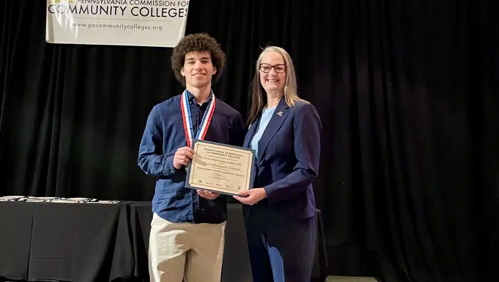 Massimiliano Simon and Dr. Vicki Bastecki-Perez, MCCC President, at the All-Pennsylvania Academic Team awards ceremony in Harrisburg. Simon received the $1,000 Chime Workforce Scholarship from Phi Theta Kappa.