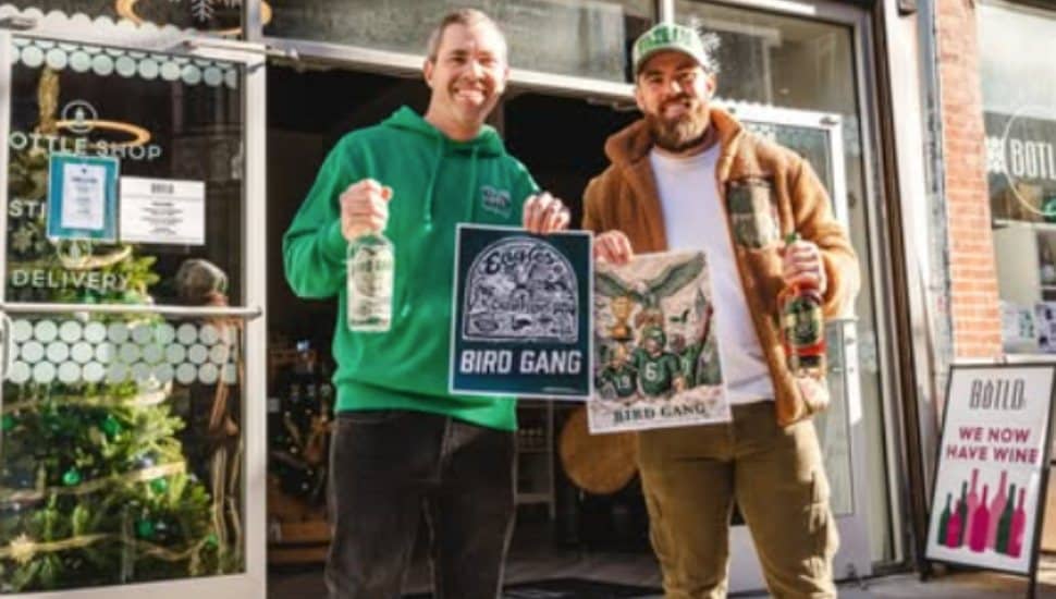 Jordan Spector and Paul Carpenter hold Bird Gang Spirits bottles outside of a Botld store.