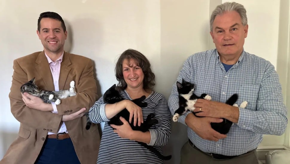 District Judge Lee Grives (left), Lisa Small and her husband Richard Small, hold cats that have been rescued from the streets.