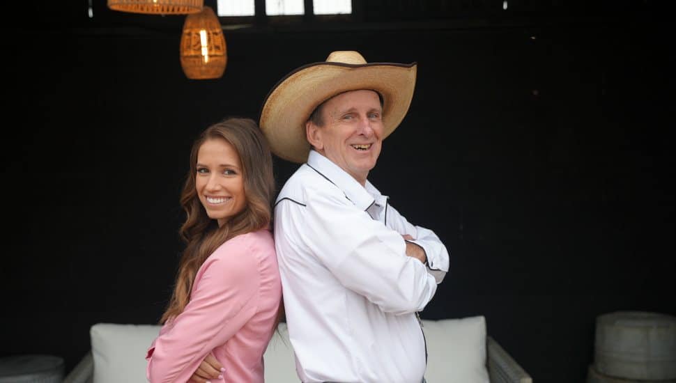 Rachel Lynn and Jeff Peiffer stand back-to-back for Flipping Farms.