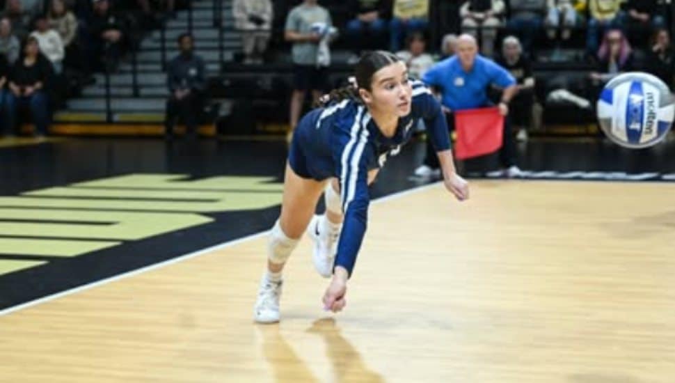 Jocelyn Nathan dives for a volleyball.