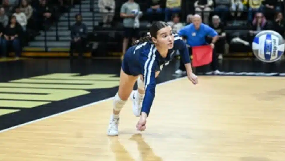 Jocelyn Nathan dives for a volleyball.