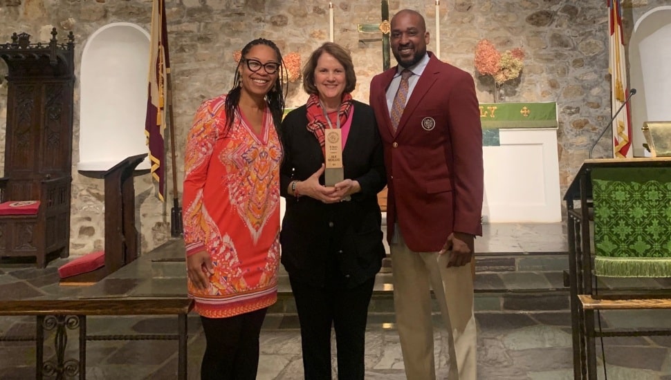 Woman honored by school’s administrators for her years of service.