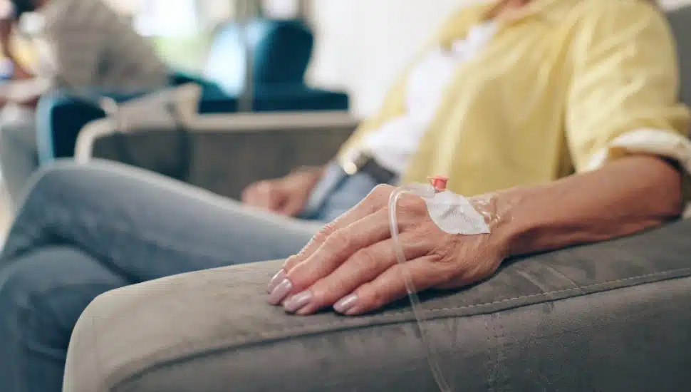 A patient sits for chemotherapy.