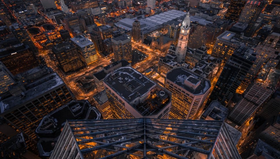 An aerial view of the Philadelphia skyline lit up at night.