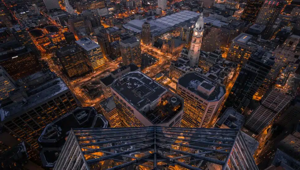 An aerial view of the Philadelphia skyline lit up at night.