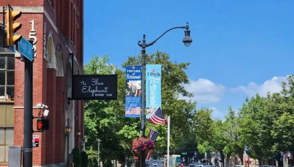 An 'iPickPottstown' sign hangs from a lantern in downtown Pottstown.