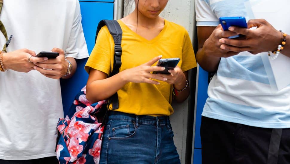 Teen students using cellphones.