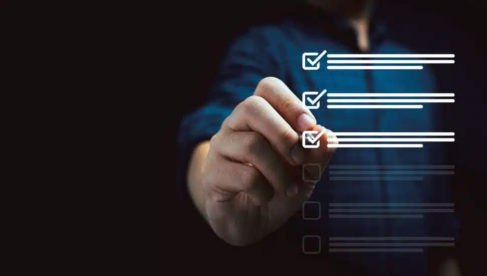 Businessman using pen to tick mark for check review and approve virtual document.