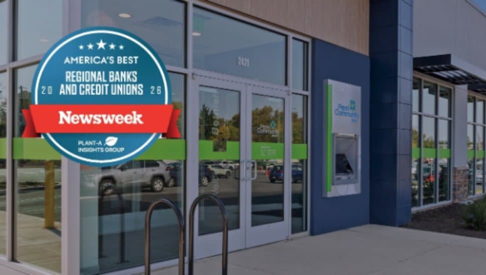 Exterior of a Penn Community Bank financial center displaying a Newsweek “America’s Best Regional Banks and Credit Unions 2026” award decal on the front window.
