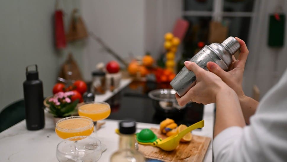 A bartender shakes up a cocktail.