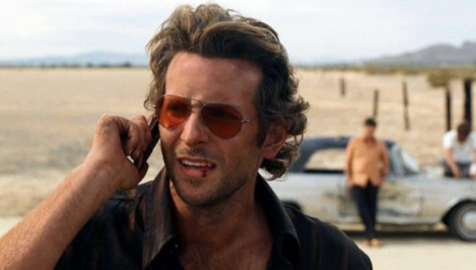 A disheveled Bradley Cooper talks on his cell phone in The Hangover.